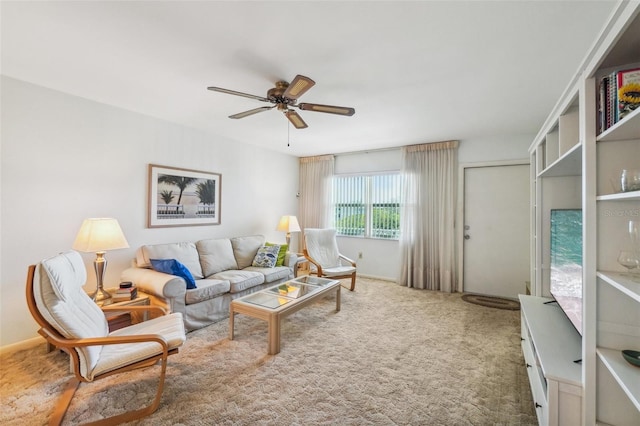 carpeted living room with ceiling fan