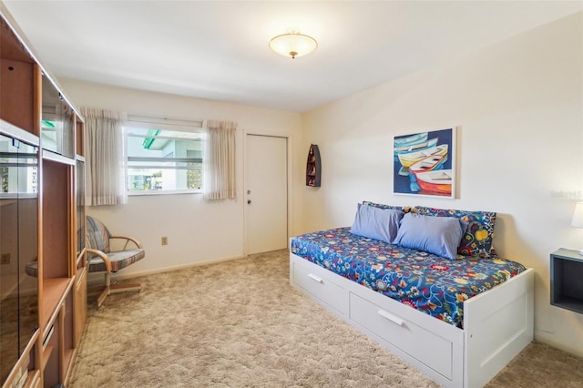 bedroom featuring light carpet