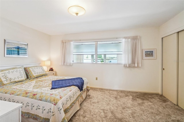 bedroom featuring a closet and light carpet