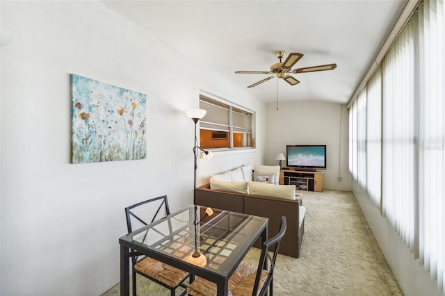 living room with ceiling fan, vaulted ceiling, and light carpet