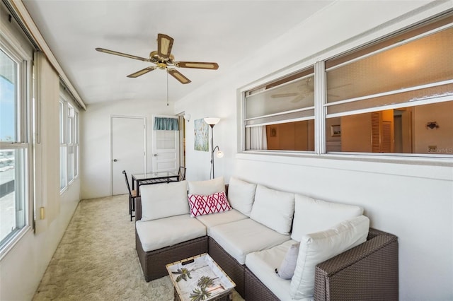 carpeted living room with vaulted ceiling and ceiling fan