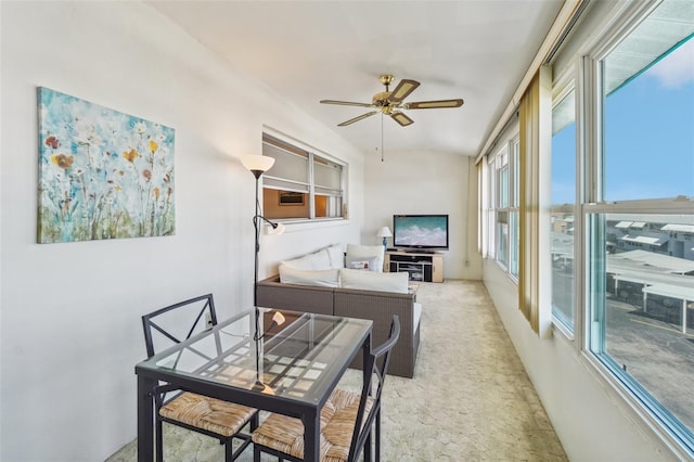 carpeted living room with ceiling fan