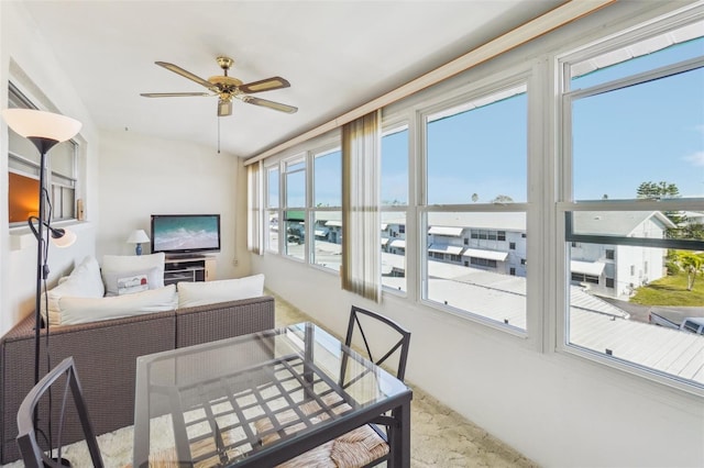 sunroom / solarium with ceiling fan and a healthy amount of sunlight