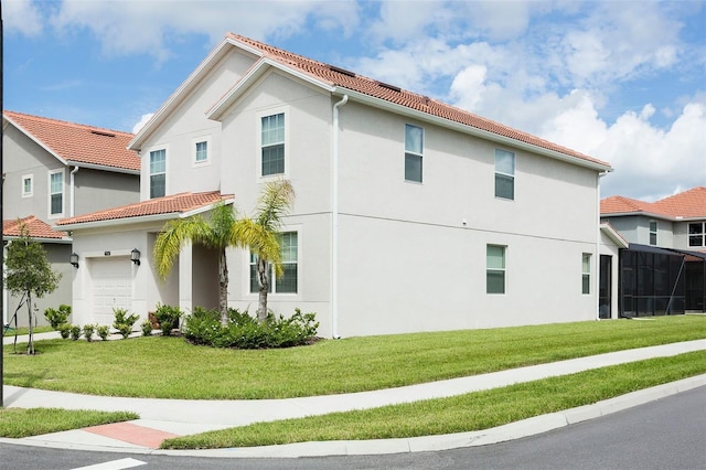 view of side of property with a garage and a lawn