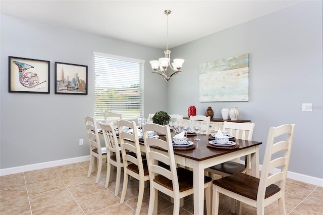 tiled dining area featuring an inviting chandelier