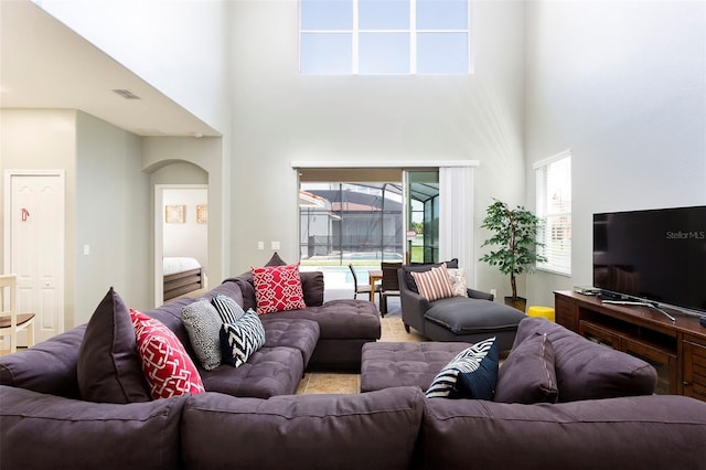 living room featuring a towering ceiling