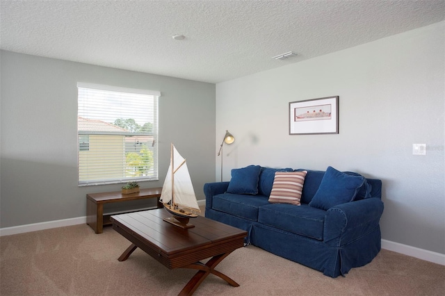 carpeted living room with a textured ceiling