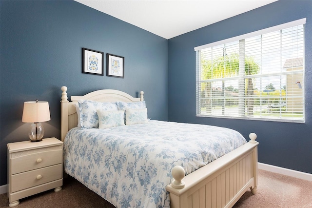 bedroom featuring dark carpet