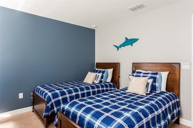 bedroom with carpet and a textured ceiling