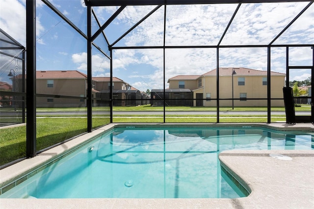 view of pool featuring a lanai and a yard