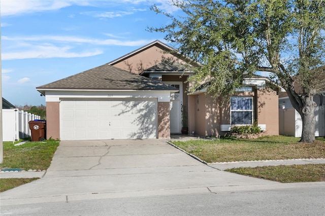 view of front of property featuring a garage and a front lawn