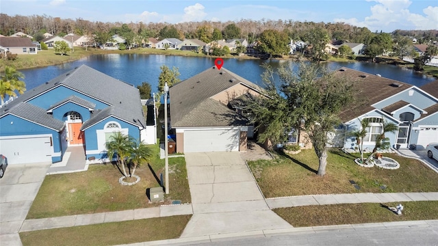 birds eye view of property with a water view