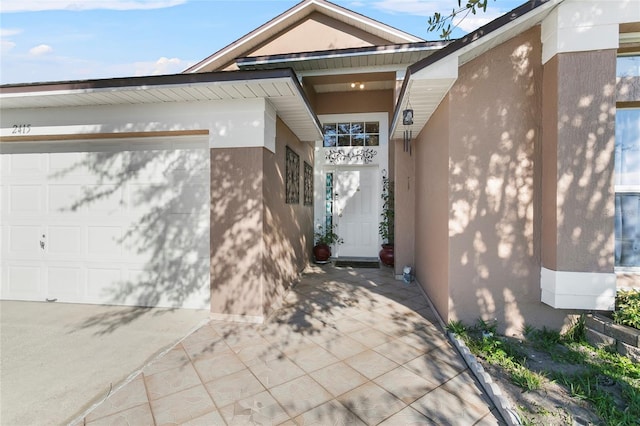 doorway to property with a garage