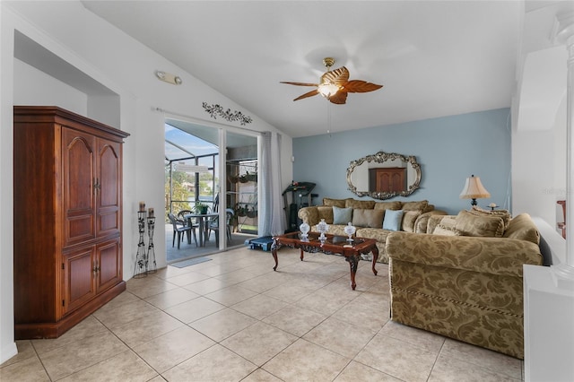 tiled living room featuring ceiling fan and vaulted ceiling