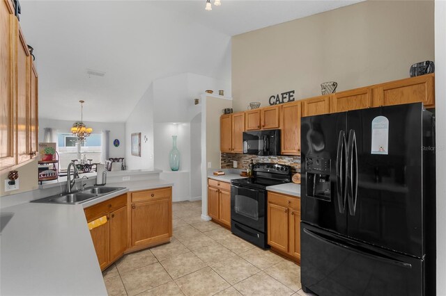 kitchen featuring tasteful backsplash, sink, black appliances, decorative light fixtures, and a notable chandelier