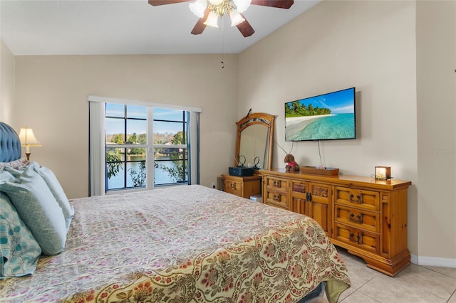 bedroom with ceiling fan, light tile patterned floors, and vaulted ceiling