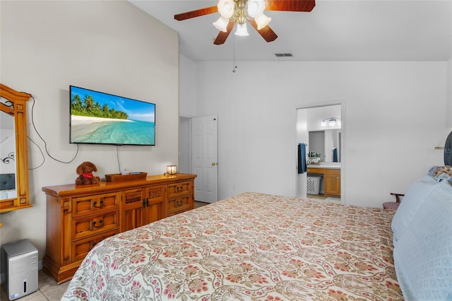 bedroom featuring ensuite bathroom, ceiling fan, and vaulted ceiling