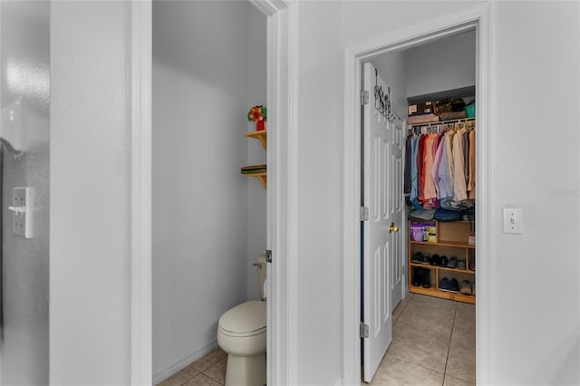 bathroom with tile patterned flooring and toilet