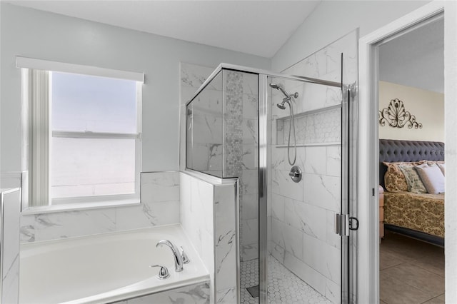 bathroom with shower with separate bathtub