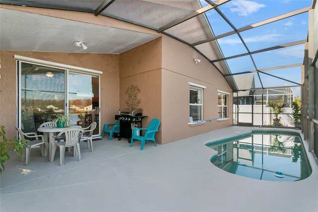 view of pool featuring glass enclosure, a grill, and a patio