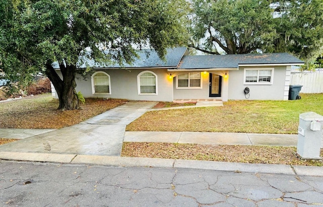 ranch-style home featuring a front yard