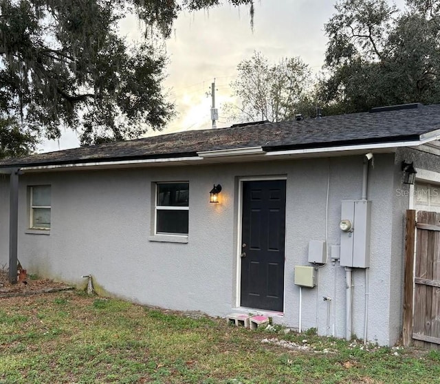 doorway to property with a yard