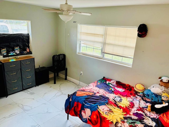 bedroom with multiple windows and ceiling fan