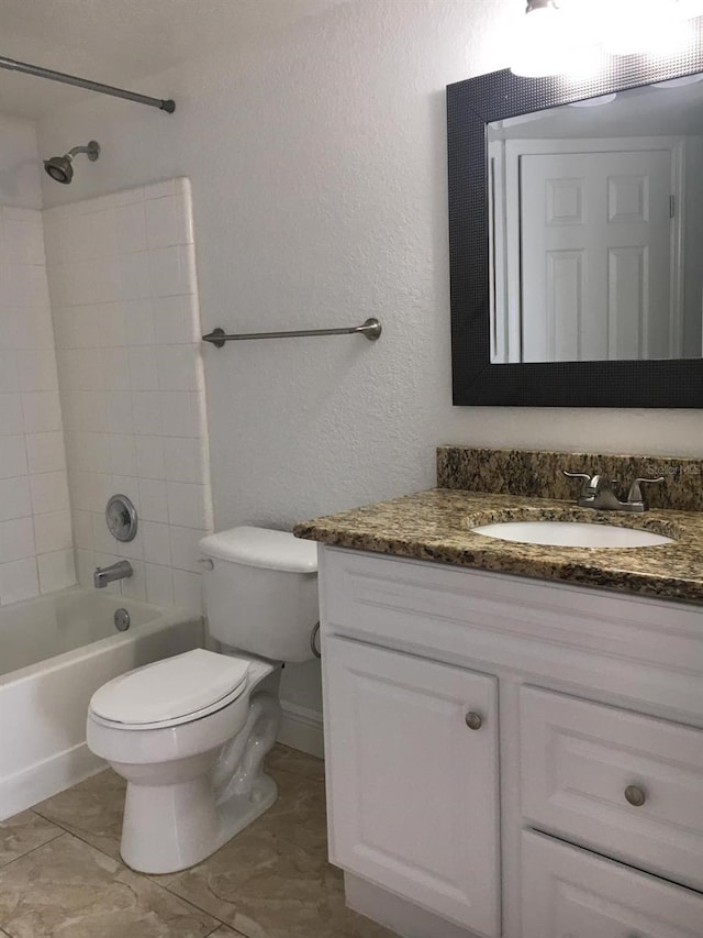 full bathroom with toilet, tile patterned floors, vanity, and tiled shower / bath combo