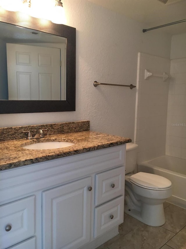 full bathroom featuring tile patterned floors, washtub / shower combination, vanity, and toilet