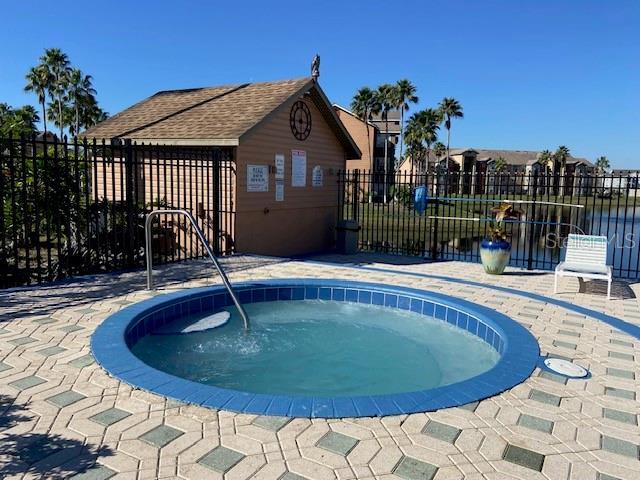 view of pool featuring a hot tub