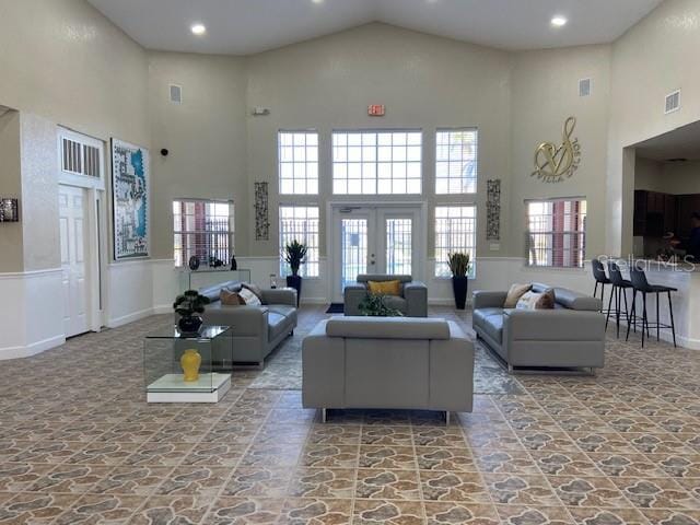 living room featuring a high ceiling and french doors