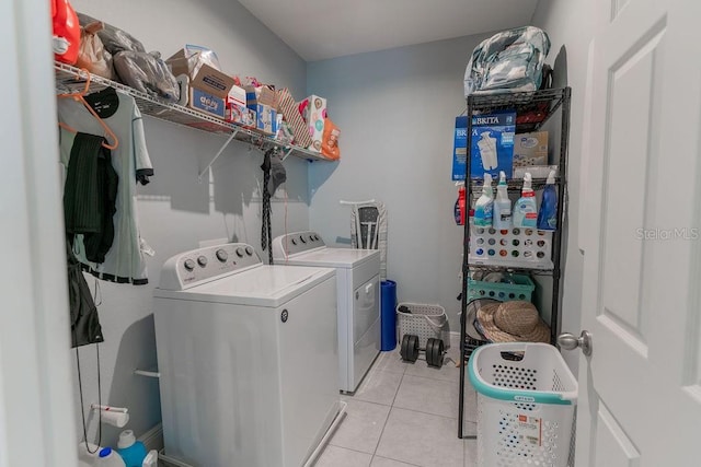 laundry room featuring washer and dryer and light tile patterned flooring