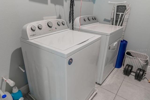 laundry room with light tile patterned floors and independent washer and dryer