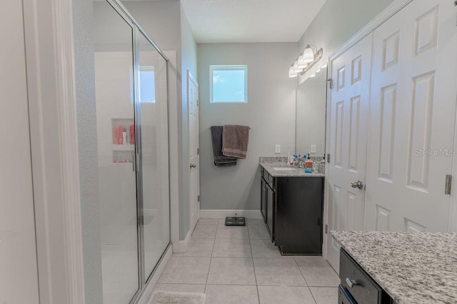 bathroom with vanity, tile patterned floors, and a shower with door