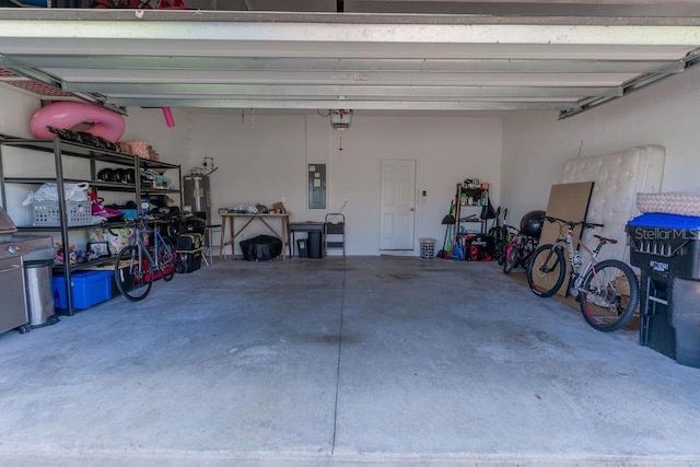 garage featuring water heater, a garage door opener, and electric panel