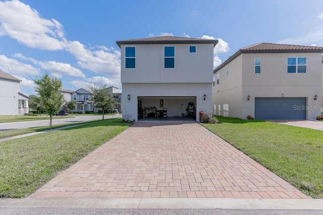 rear view of property with a garage and a yard