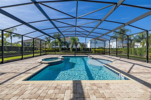 view of swimming pool featuring a lanai, an in ground hot tub, and a patio