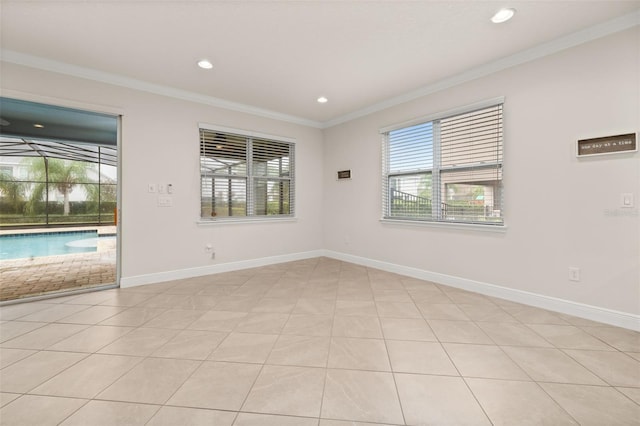 spare room with light tile patterned floors and crown molding