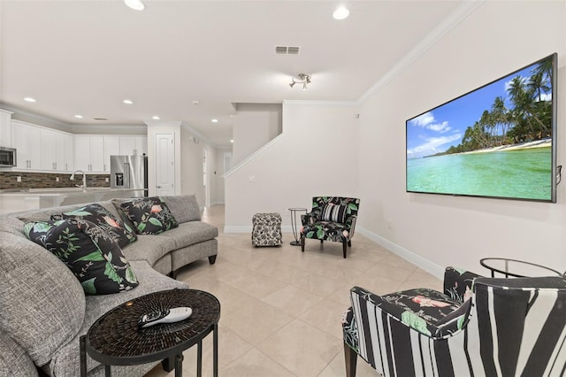 living room with light tile patterned floors and ornamental molding