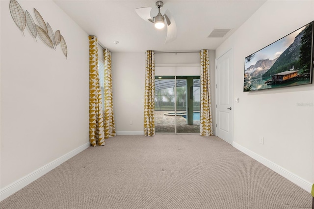 empty room with carpet flooring and ceiling fan