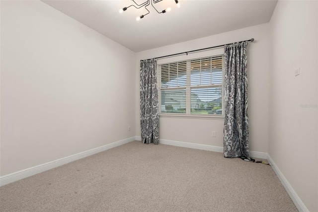 unfurnished room featuring light colored carpet