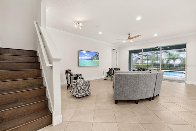 living room with ceiling fan, light tile patterned floors, and ornamental molding