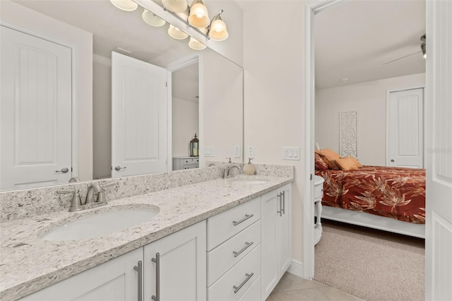 bathroom with tile patterned flooring, vanity, and ceiling fan