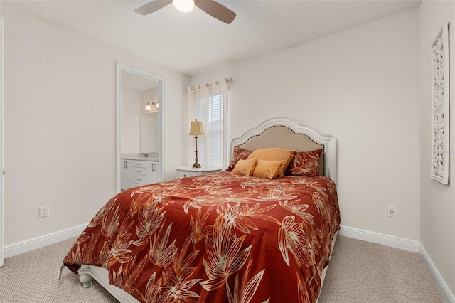 carpeted bedroom featuring ensuite bathroom and ceiling fan