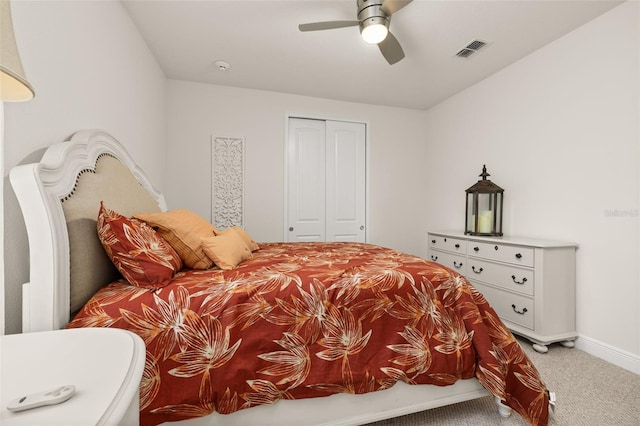 carpeted bedroom featuring ceiling fan and a closet