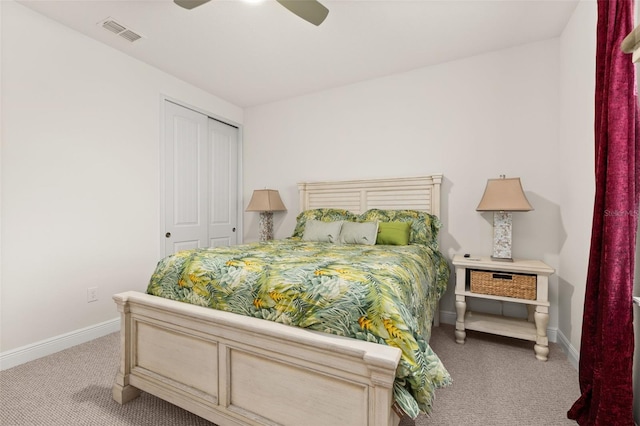 carpeted bedroom featuring ceiling fan and a closet