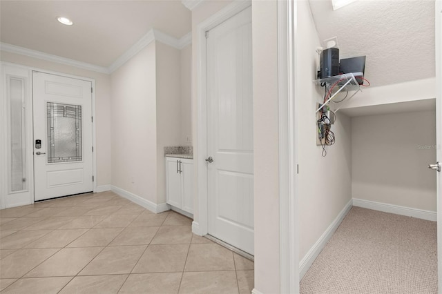 corridor featuring crown molding and light tile patterned floors