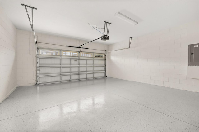 garage with electric panel and a garage door opener