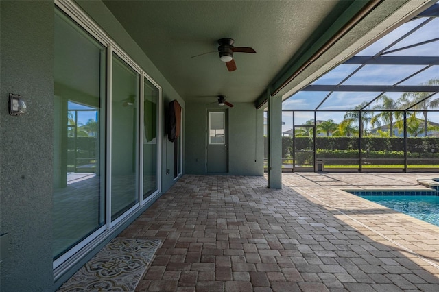 view of patio featuring ceiling fan and a lanai