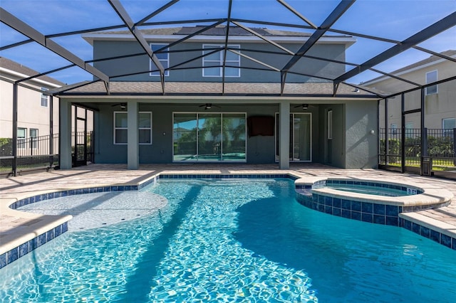 view of pool featuring a lanai, ceiling fan, a patio, and an in ground hot tub